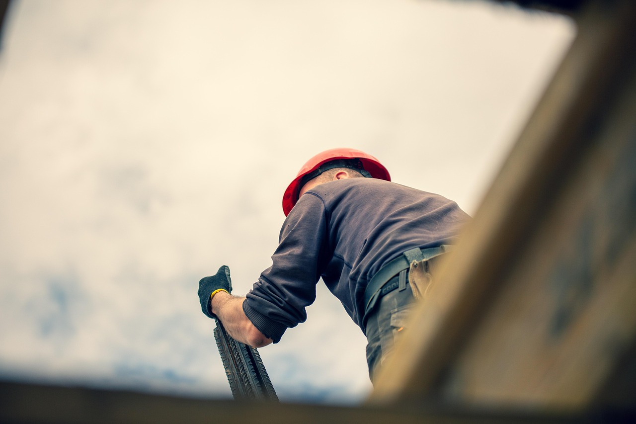 Construction worker on scaffolding demonstrating workplace safety in New York